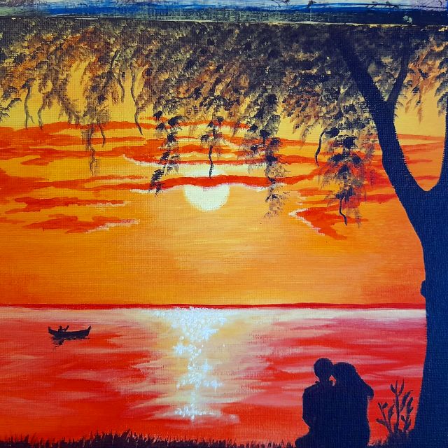 Coppia sotto un albero al tramonto sul mare